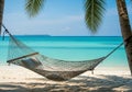 A tranquil beach scene featuring a hammock strung between two Royalty Free Stock Photo