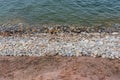 Tranquil beachfront view of a rocky shoreline situated along a picturesque cliff