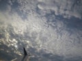 Tranquil Beautiful View From Plane Window at Blue Sky over White Clouds with a Wing Royalty Free Stock Photo