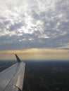 Tranquil Beautiful View From Plane Window at Blue Sky over White Clouds with a Wing Royalty Free Stock Photo