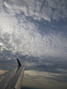 Tranquil Beautiful View From Plane Window at Blue Sky over White Clouds with a Wing Royalty Free Stock Photo