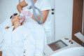 Experienced cosmetician conducting the facial rejuvenation procedure