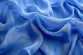 Tranquil blue silk ripples flowing fabric abstract background with space for text
