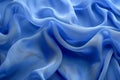 Tranquil blue silk ripples flowing fabric abstract background with space for text Royalty Free Stock Photo