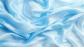 Tranquil blue silk waves flowing fabric abstract background with ample copy space