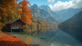 Tranquil cabin by a calm lake surrounded by a forest ablaze with autumn colors, reflecting a serene atmosphere. Royalty Free Stock Photo