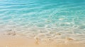 Tranquil close up aerial view of gentle ocean waves washing up on a serene sandy beach shoreline