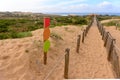 Tranquil Coastal Path with direction indicator and Wooden and Rope Fence at Cabo da Roca, Beach Guinch Royalty Free Stock Photo
