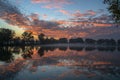 Tranquil colorful sunset at lake with benches on coast