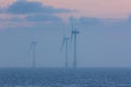 Tranquil environment scene at sea. Offshore wind farm turbines o