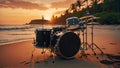 Drum kit silhouetted against the sunset on a serene beach