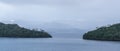 Tranquil evening on Lake Pedder with beautiful hills silhouetted Royalty Free Stock Photo