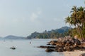 Tranquil evening at a tropical beach with people kayaking and walking along the shore Royalty Free Stock Photo