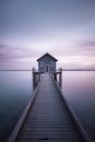 A Tranquil Evening: The Wooden Walkway Leading to a Lake House at Sunset, ai generative