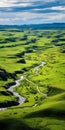 Tranquil Green Valley: Aerial View Of Vibrant Badlands And Swaying Grasslands Royalty Free Stock Photo