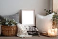 Cozy Neutral Corner with Frame, Cushions, and Candles Royalty Free Stock Photo