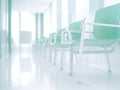 Tranquil hospital interior with empty green chairs and a bright, airy atmosphere.