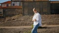 Tranquil lady stepping landscape alone. Blonde woman spending vacation at castle