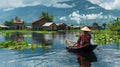 A tranquil lake in Asia, with a stilt house and rower. Generative AI