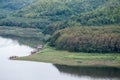 Tranquil lake with the cottage raft in the reservoir