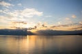 Tranquil lake illuminated by the setting sun, casting a mesmerizing reflection