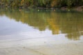 Tranquil lake reflecting the autumn trees Royalty Free Stock Photo