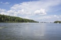 A tranquil lake scene featuring sailing boats and lush greenery under a bright sky. Ideal for nature lovers and outdoor enthu