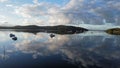 Tranquil lake scene featuring small boats floating on the water