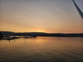 Tranquil lake scene with a golden sunset sky illuminating the horizon Royalty Free Stock Photo