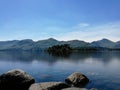 A tranquil lake scene with a mountain ridgeline behind