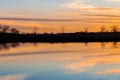 Tranquil lake scenery with evening orange sky reflection Royalty Free Stock Photo