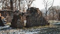 some large stone ruins with a tree in the background and snow on the ground