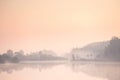 Tranquil Landscape with sunrise over lake. Morning beautiful clouds on sky. Trees and forest reflection in water scene. Calm misty Royalty Free Stock Photo