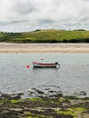Tranquil Middle Ring Bay Beach in Ireland with a Small Boat Floating on Calm Waters Royalty Free Stock Photo