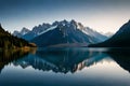A tranquil, mirror-like lake reflecting a snow-covered mountain peak in its crystal-clear waters Royalty Free Stock Photo