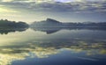 Tranquil Misty morning scene of trees reflected in a still lake