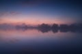 Tranquil misty sunrise on lake