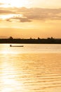 A tranquil morning lake and asian fisherman on fishing boat Royalty Free Stock Photo