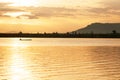 A tranquil morning lake and asian fisherman on fishing boat Royalty Free Stock Photo