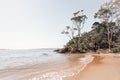 Tranquil ocean beach cove with gentle waves lapping the sandy shore Royalty Free Stock Photo