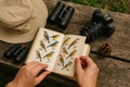 Exploring birdwatching with binoculars, a field guide, and a camera in a serene outdoor setting Royalty Free Stock Photo