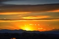 Tranquil panoramia scene of red sun and orange sky sunset over the Rocky Mountains in Colorado by Denver Royalty Free Stock Photo