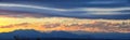 Tranquil panoramia scene of red sun and orange sky sunset over the Rocky Mountains in Colorado by Denver Royalty Free Stock Photo