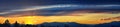 Tranquil panoramia scene of red sun and orange sky sunset over the Rocky Mountains in Colorado by Denver Royalty Free Stock Photo