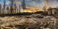 A tranquil panoramic view of river water flowing through the stones with dramatic cloud movement in the sky long exposure