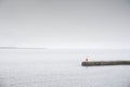 Tranquil peaceful water stone jetty pier at lake