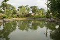 tranquil pond inside the temple premises surrounded by abundant greenery