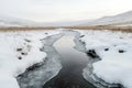 A tranquil river flows gently through a snow-covered valley, surrounded by rolling hills Royalty Free Stock Photo