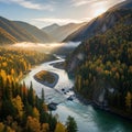 A tranquil river meanders through a valley surrounded by dense forests in autumn Royalty Free Stock Photo