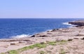 Tranquil rocky coastal line without people at winter in Marsaskala, Malta Royalty Free Stock Photo